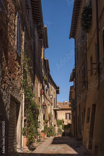 Fototapeta Naklejka Na Ścianę i Meble -   Beautiful narrow street in the small magical and old village of Pienza, Val D'Orcia Tuscany - Italy