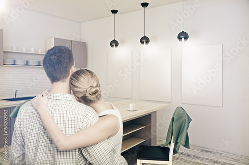Young couple looking at new kitchen