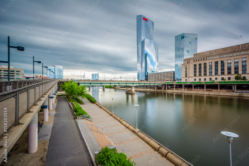 Long exposure of modern buildings and walkway along the Schuylkill River in Philadelphia, Pennsylvania.