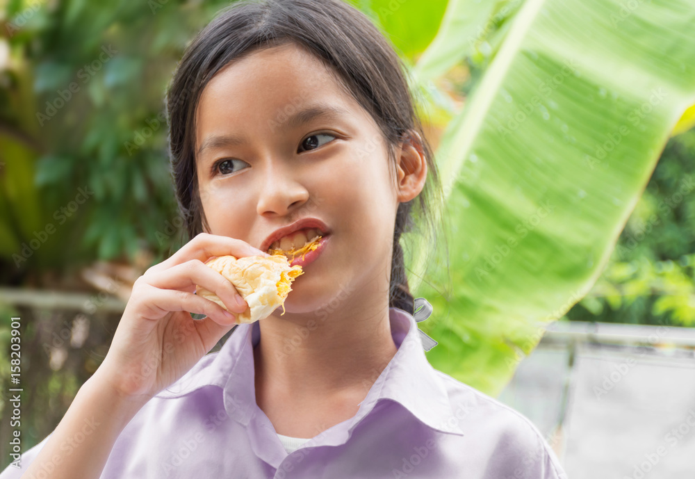 The girl was eating bread with delicious. The girl was eating bread with delicious.