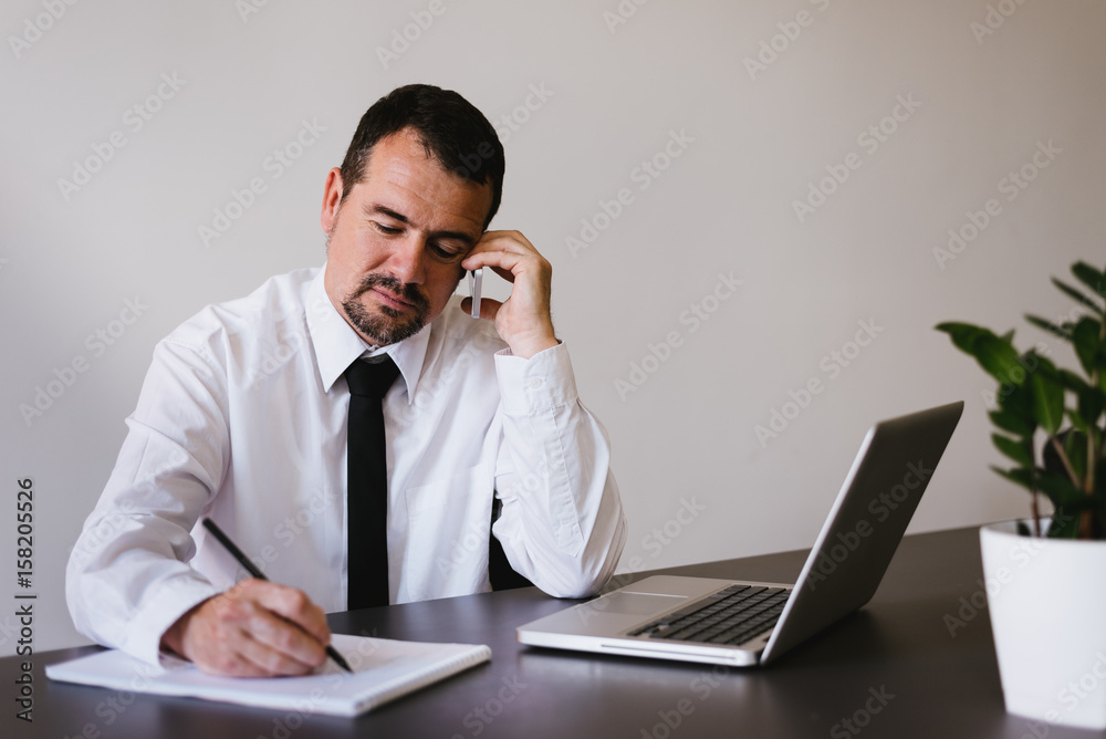 Manager writing notes for meeting Manager writing notes for meeting