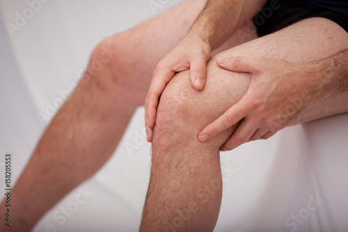 Man holding his knee