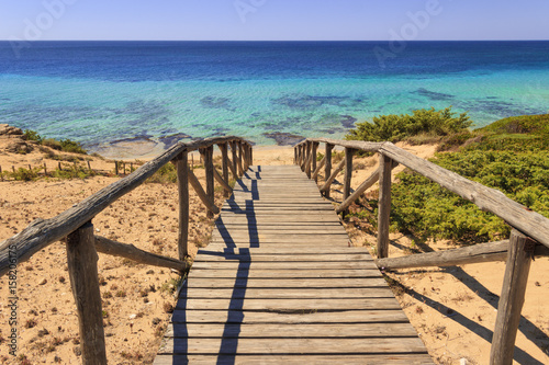 The most beautiful beaches of Italy. Campomarino dune park: fence between sea dunes,Taranto (Apulia). The protected area extends along the entire coast of the town of Maruggio. photo