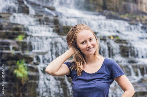 Young woman hiker, tourist on the background of Amazing Pongour Waterfall is famous and most beautiful of fall in Vietnam. Not far from Dalat city estimate 45 Km. Dalat, Vietnam photo