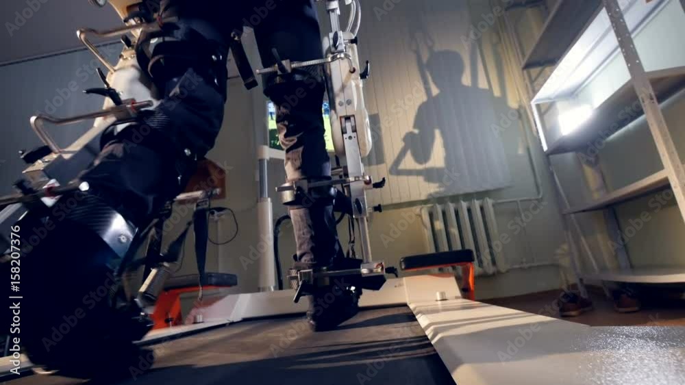 A patient during training therapy with robotic support. A patient during training therapy with robotic support.