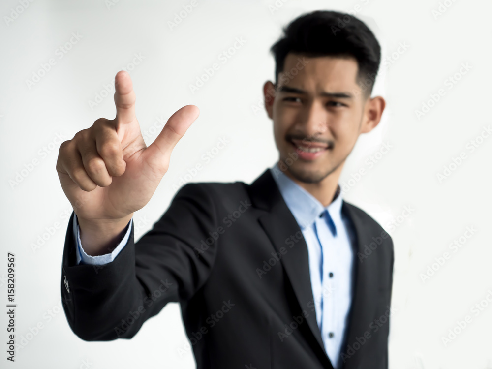 Businessman touching on a virtual screen Businessman touching on a virtual screen
