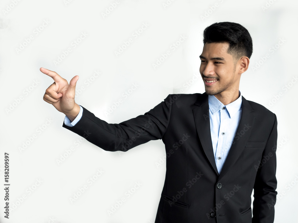 Asian businessman in suit pointing on white background Asian businessman in suit pointing on white background