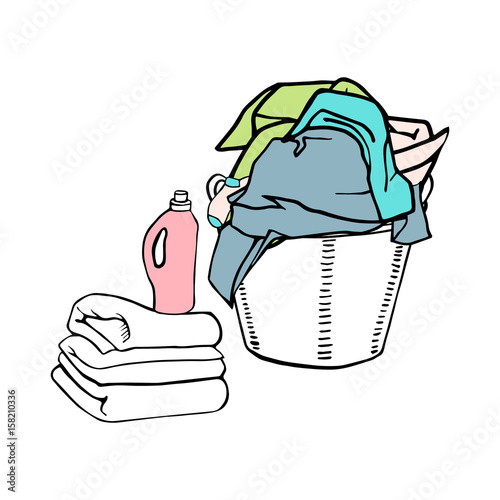 Full laundry basket with clothes, textiles and bed linen. Clean sheets and a detergent.