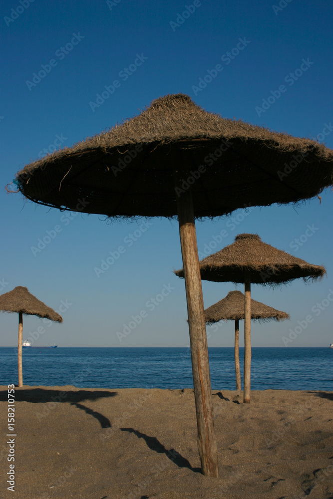 Straw umbrellas on a beautiful tropical beach