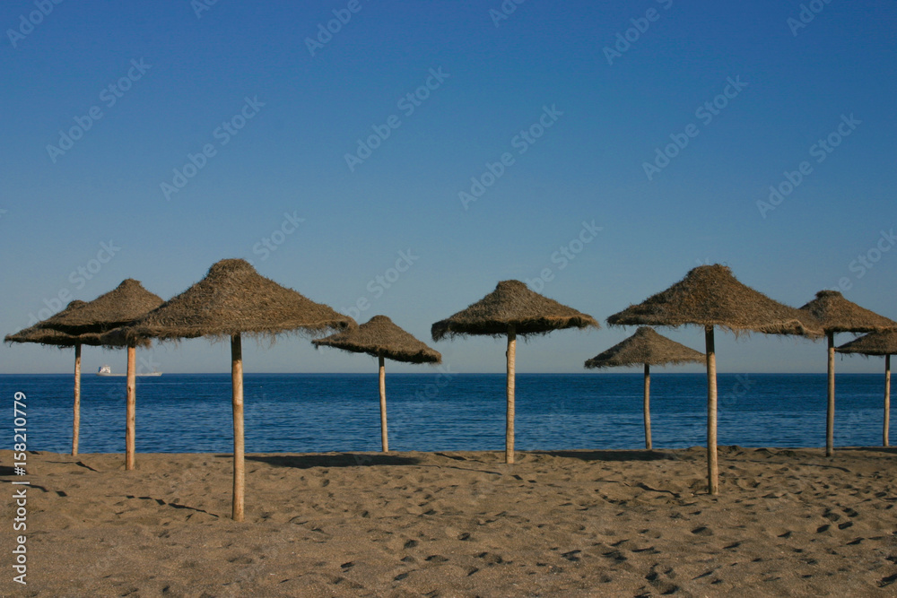 Straw umbrellas on a beautiful tropical beach