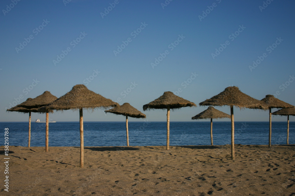 Straw umbrellas on a beautiful tropical beach