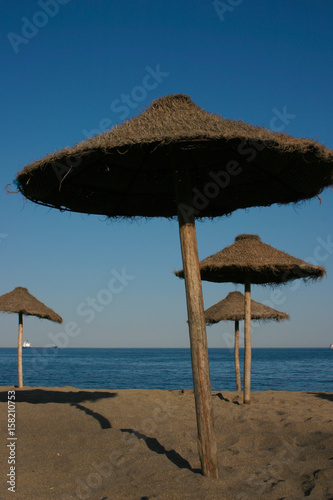 Straw umbrellas on a beautiful tropical beach