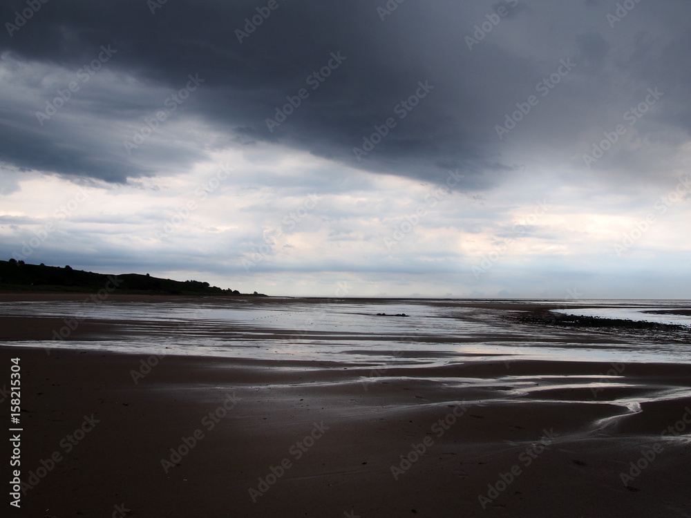 heavy storm on a beach with dark clouds