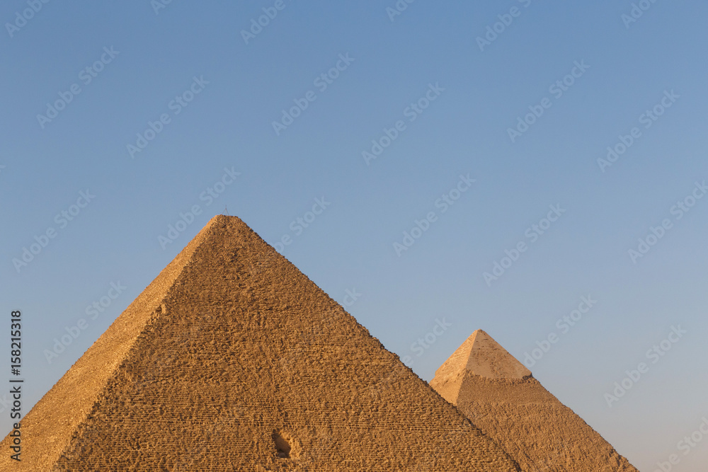 pyramids of Khufu and Khafre against blue sky pyramids of Khufu and Khafre against blue sky