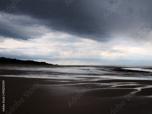 heavy storm on a beach with dark clouds