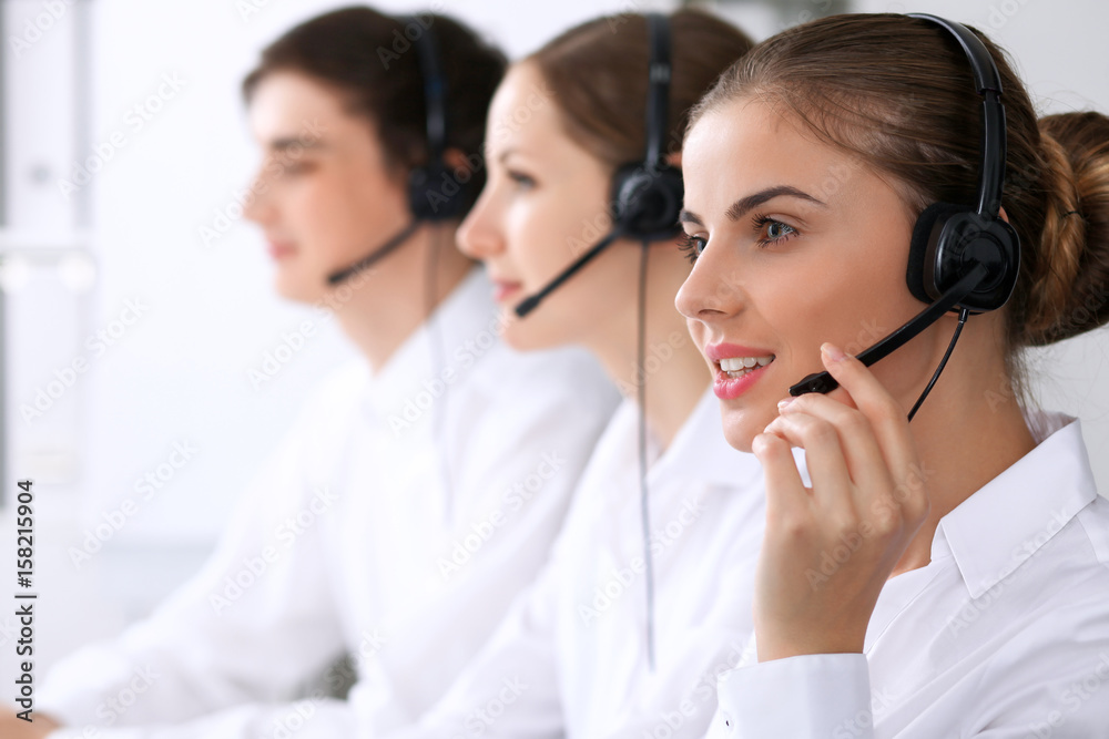 Call center. Focus on beautiful woman in headset Call center. Focus on beautiful woman in headset