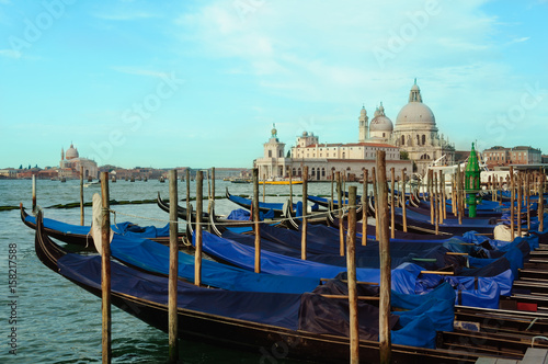 Venice cityscape view on Santa Maria della Salute basilica with gondolas on the Grand canal in Venice