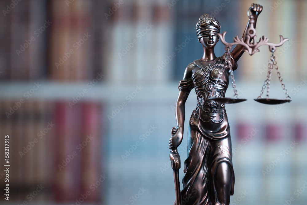 Lady Justice and law books in court Lady Justice and law books in court