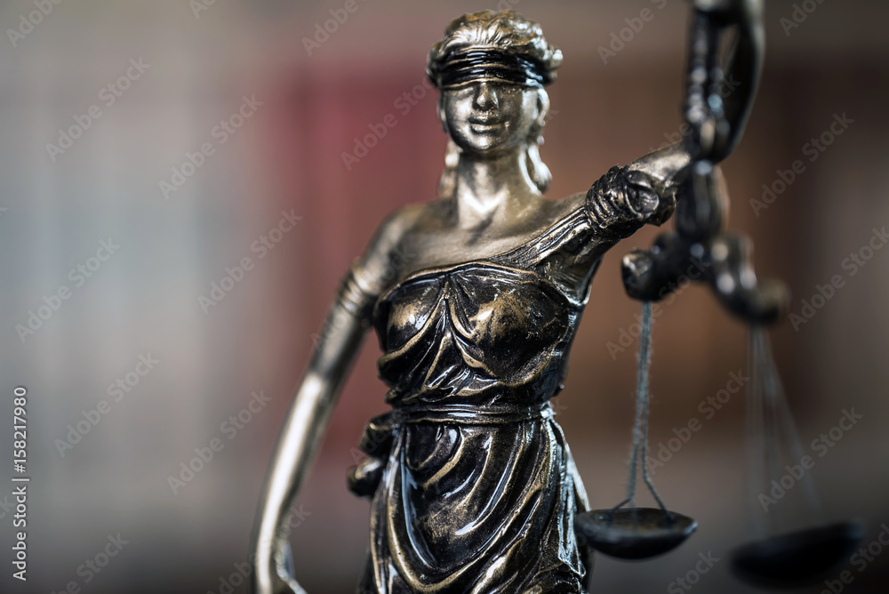 Lady Justice and law books in court