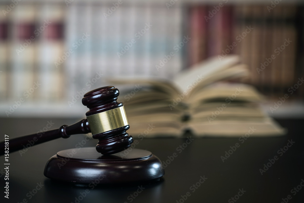 Judge hammer, scales of justice and law books in court Judge hammer, scales of justice and law books in court