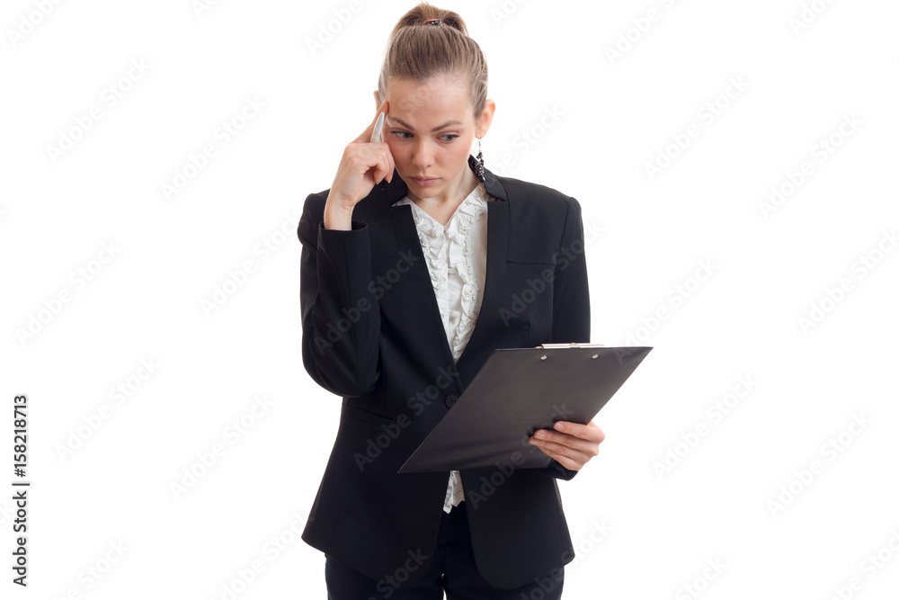 a young thoughtful business woman in black suit with the Tablet keeps finger near the temple a young thoughtful business woman in black suit with the Tablet keeps finger near the temple