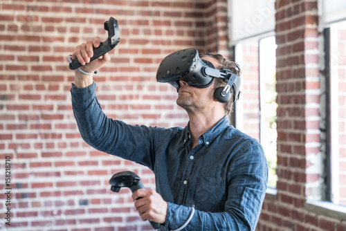 A caucasian man wearing a virtual reality headset.