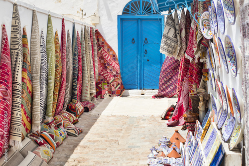 yard with carpets and blue door in Tunisia © sergejson