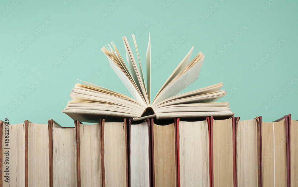 Naklejka premium Open book, hardback books on wooden table. Education background. Back to school. Copy space for text.