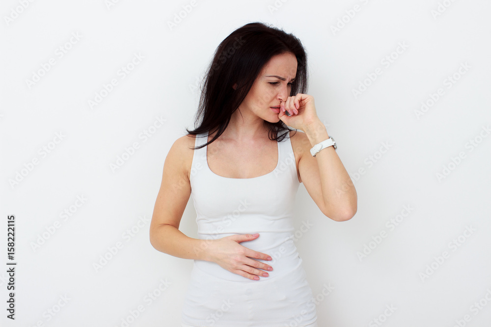 Woman with pain is holding her aching belly Woman with pain is holding her aching belly