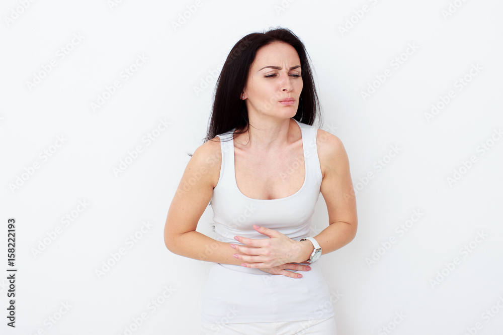 Woman with pain is holding her aching belly Woman with pain is holding her aching belly