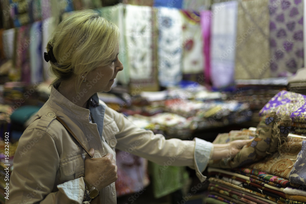 Middle aged woman in storefront shopping in Grand Bazaar,Istanbul