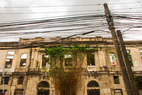 Abandoned old building, overgrown with vines. Manila, Philippines.