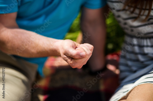 man holding in his hands the compressed surprise, a date, love confession, a marriage proposal, the relationship between man and woman,picnic © bondvit