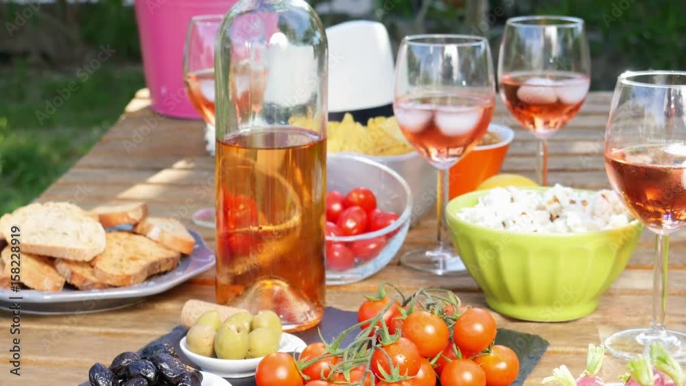 holiday summer brunch party table outdoor in a house backyard with appetizer, glass of rosé wine, fresh drink and organic vegetables holiday summer brunch party table outdoor in a house backyard with appetizer, glass of rosé wine, fresh drink and organic vegetables