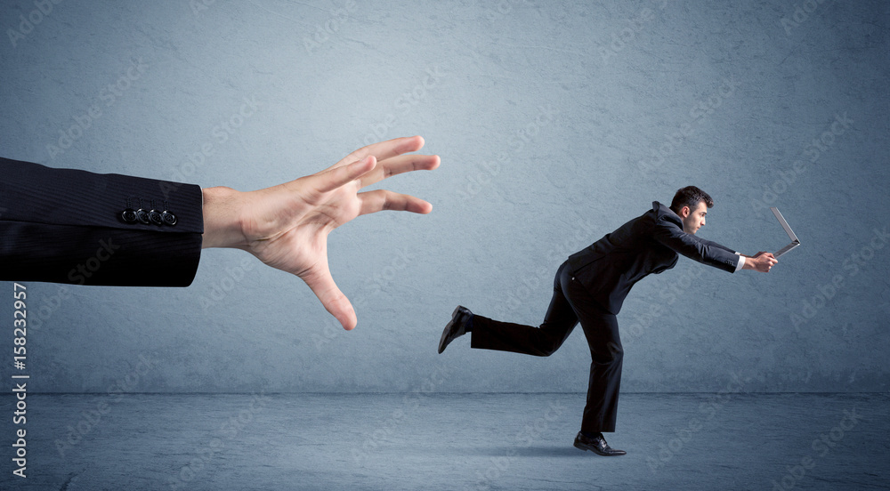 Businessman running from hand