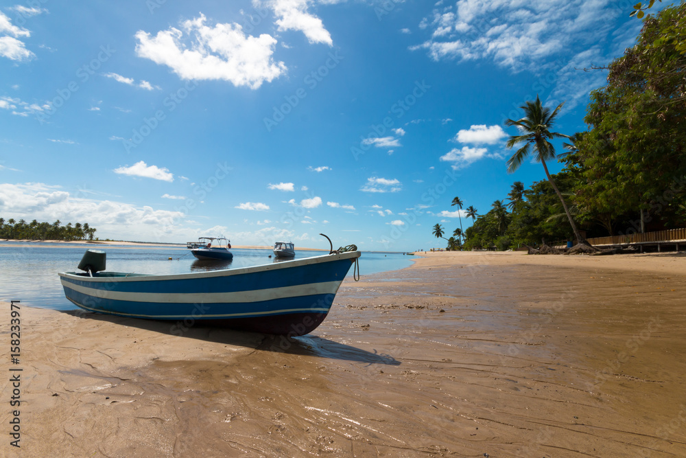 Tropical island paradise with boats on deserted beach