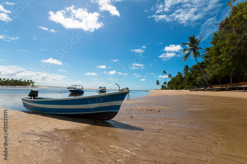 Tropical island paradise with boats on deserted beach