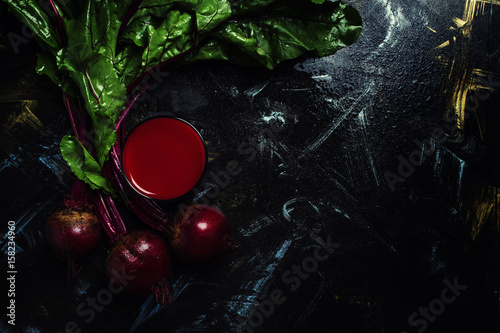 Juice of their fresh beets, dark background, top view