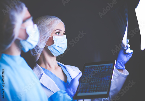 Medical team speaking of a X-ray in an operating room photo