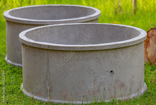Two cement ponds on the grass.