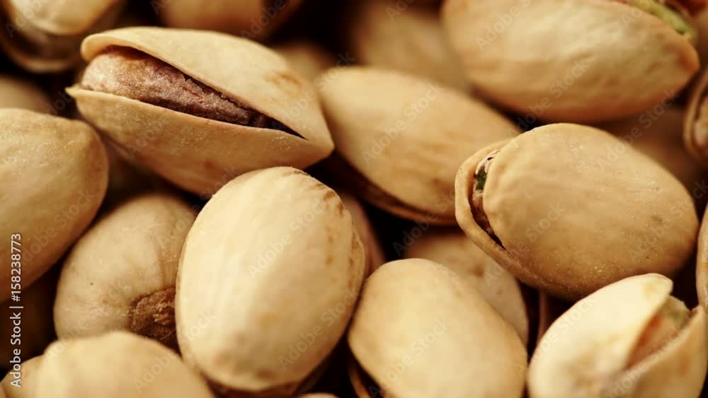 Food background. Roasted pistachio nuts seed with shell close up. Dieting concept. Dolly slider shot 4K ProRes HQ codec Food background. Roasted pistachio nuts seed with shell close up. Dieting concept. Dolly slider shot 4K ProRes HQ codec