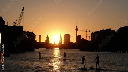 Sunset sky Berlin Panorama - river Spree, Oberbaum Bridge, Tv Tower and stand up paddle board people 