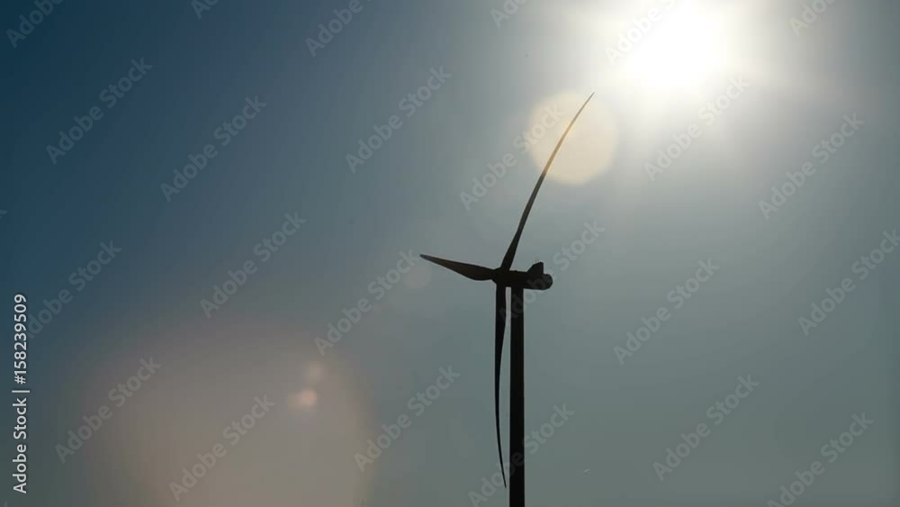 silhouette of wind turbine and the sun silhouette of wind turbine and the sun