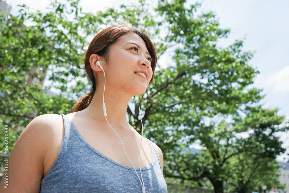Young woman runnning with listening to music 