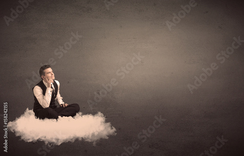 Man sitting on a cloud with plain background