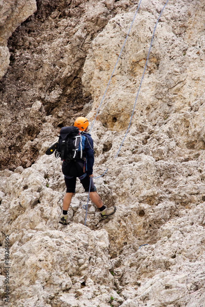 A climber is climbing down the high Alps mountain A climber is climbing down the high Alps mountain