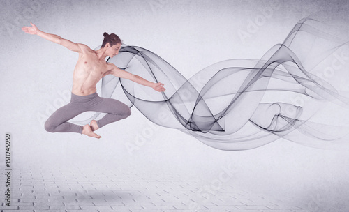 Modern ballet dancer performing with abstract swirl