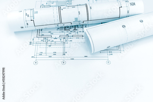 architectural plan and rolls of technical drawings of new home