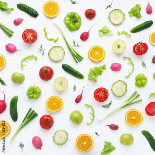 Vegetables and fruits on a white background. Pattern of vegetables and fruits. Food background. Collage of food. Top view. Composition of pears, green peppers, cucumbers, green radish, tomatoes, green