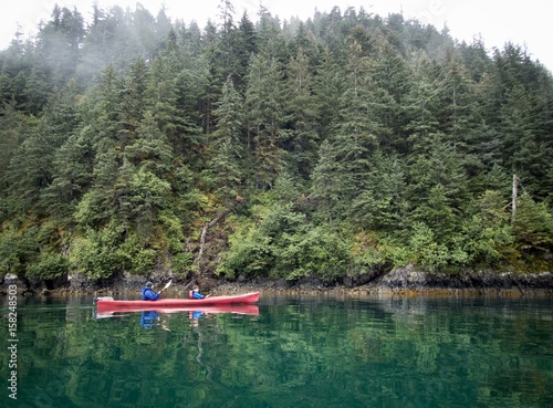 Father and son kayaking in Resurrection Bay, near Seward, Alaska photo